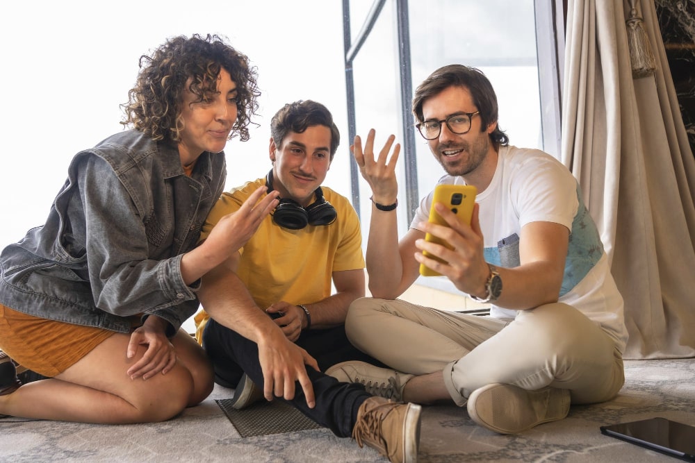Happy people on the table with phone